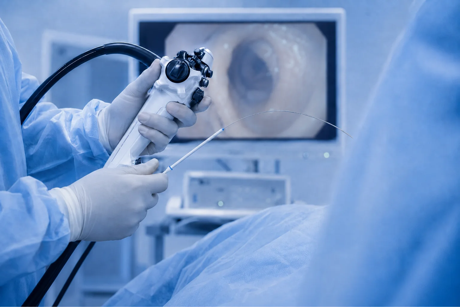 A clinician operating an endoscope during a therapeutic procedure.